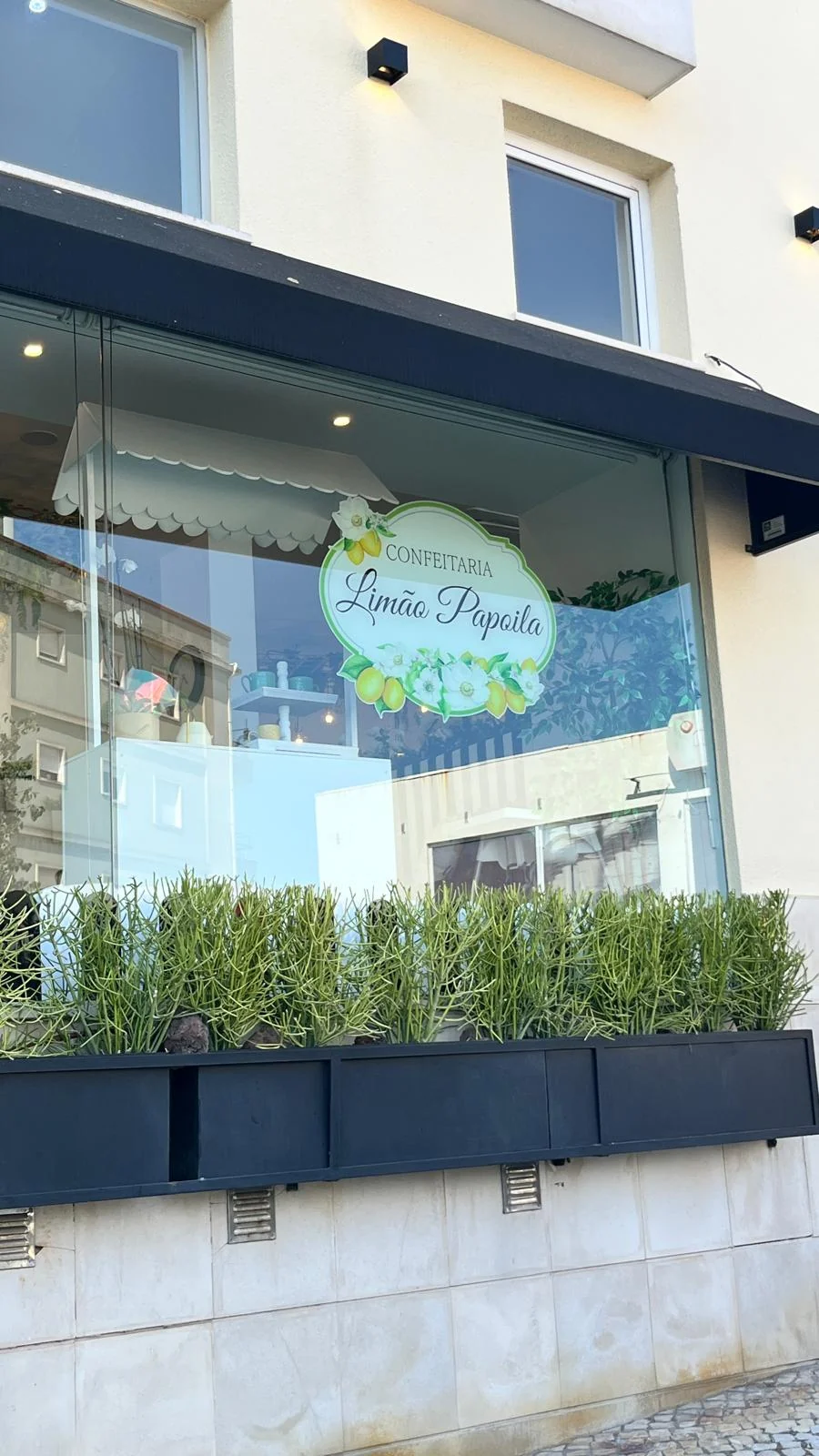 Fachada envidraçada com o letreiro Confeitaria Limão Papoila